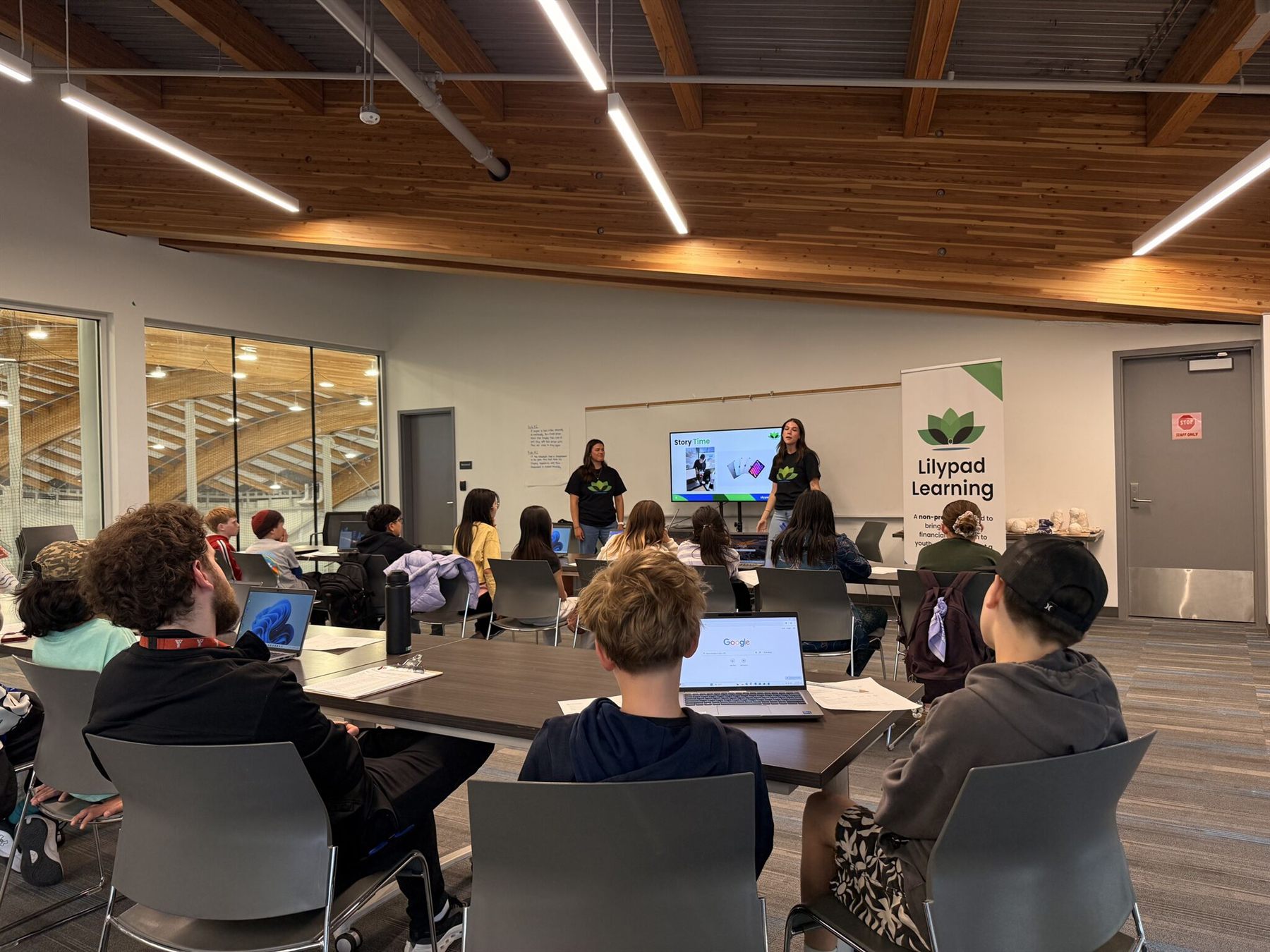 Two educators leading the Story Time segment in a bright community room