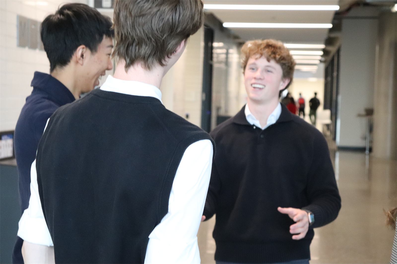 Lilypad Learning team members talking in a university hallway